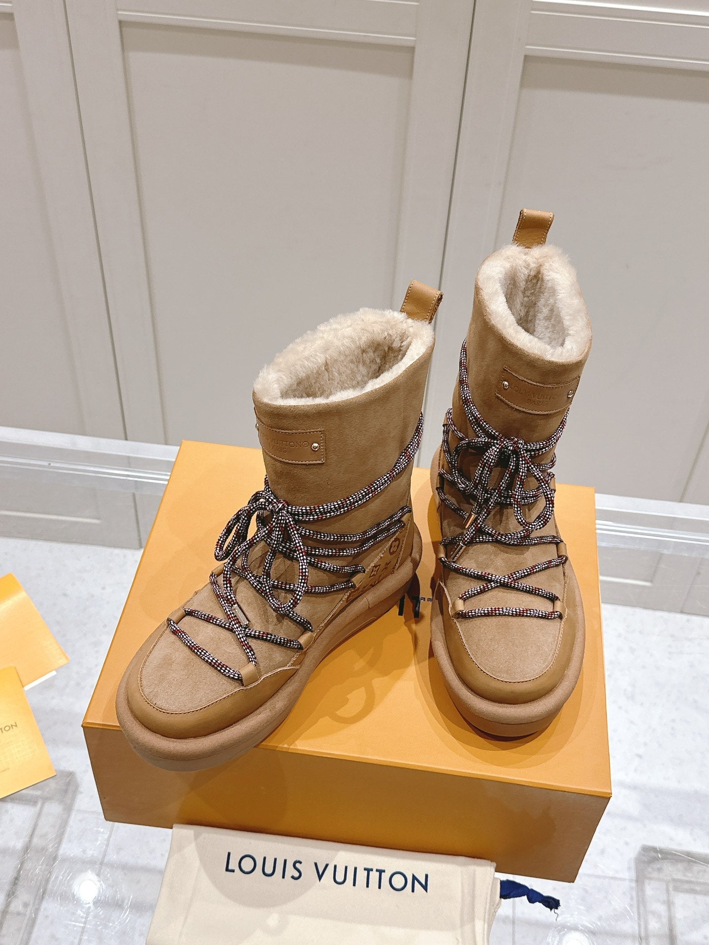 ASPEN PLATFORM ANKLE BOOT IN CIDER BROWN MONOGRAM DEBOSSED SUEDE AND SHEARLING